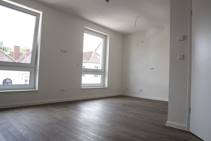 Appartement mit großem Fenster und Blick über die Dächer